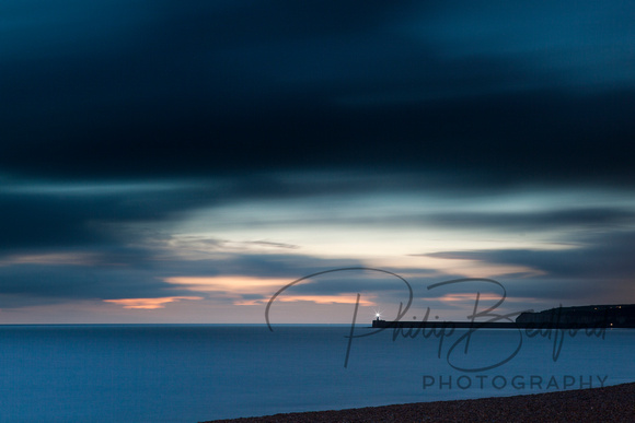 Newhaven lighthouse from Seaford beach at Twilight - long exposure